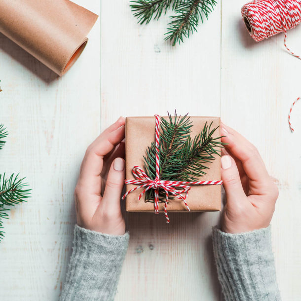 Woman packing presents for Christmas in boxes