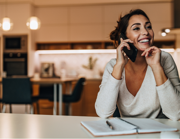 Woman learns how to fix her credit score while talking on the phone with a KOFE coach.