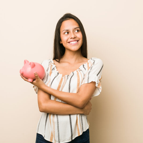 A woman holding a piggy bank