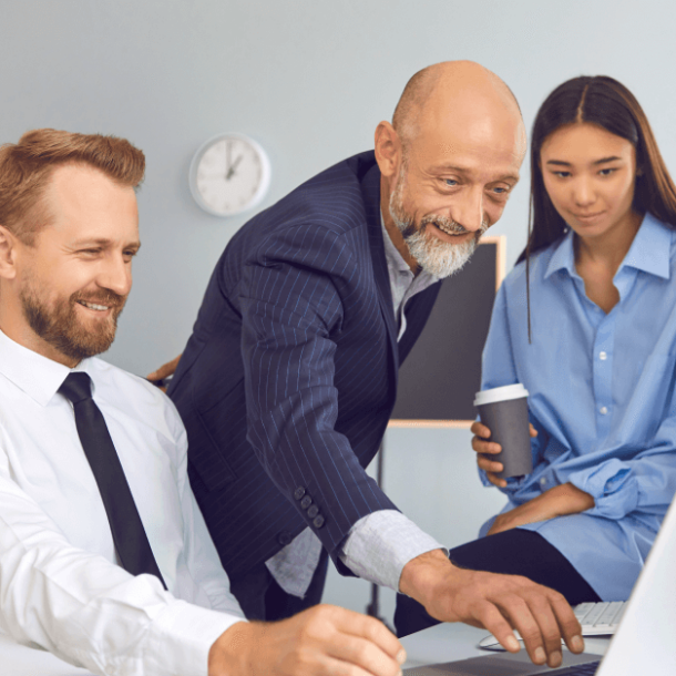 Happy office workers using laptop to work on project or to watch funny video during break