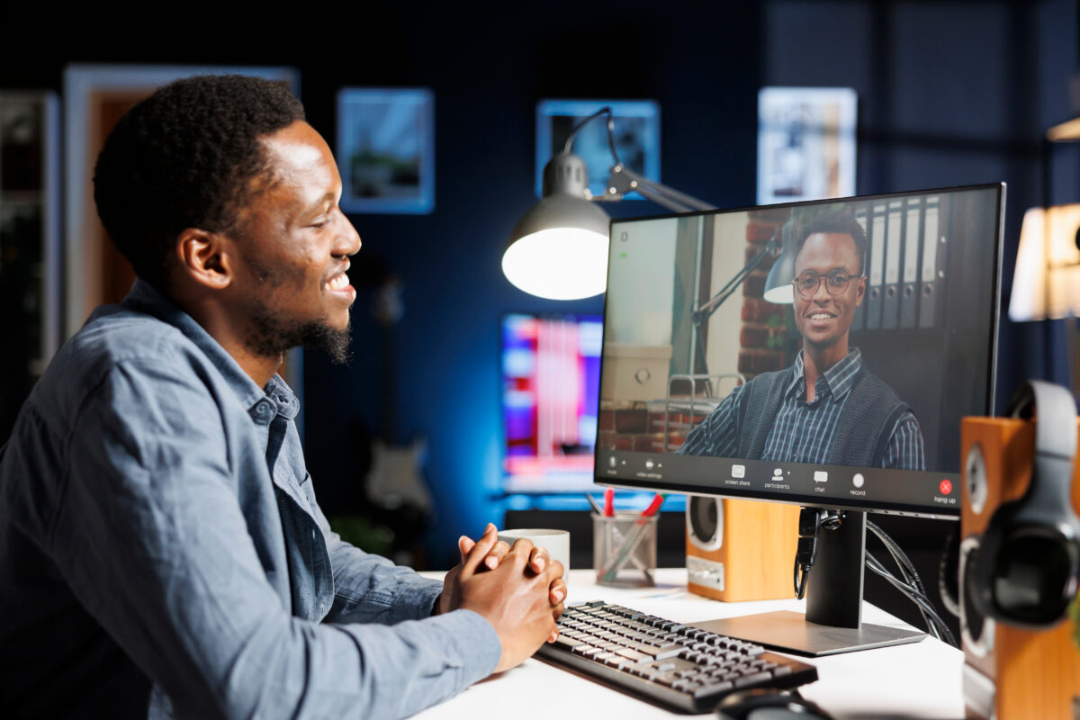 Recruiter interviewing another man on a video chat