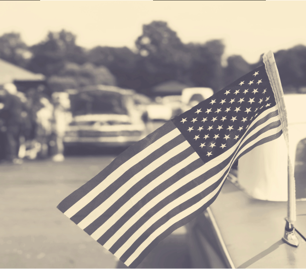Black and white photo of an American flag on a street