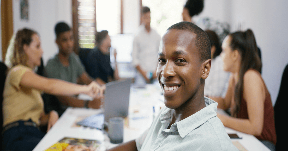 Teamwork, portrait of businessman and people in a business meeting. Collaboration or diversity, communication or planning and coworkers talking or brainstorming at a table at their workplace