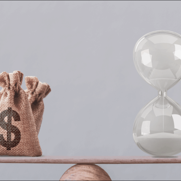 Financial concept : Write sand clock or hourglass symbol and dollar bagson a balance scale in equal position.Time value of money, asset growth over time, investment in long-term equity for more money